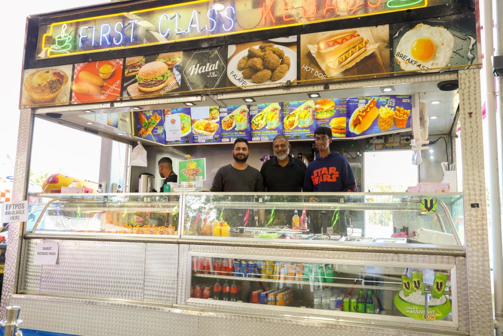 Image of three men smiling in food truck 