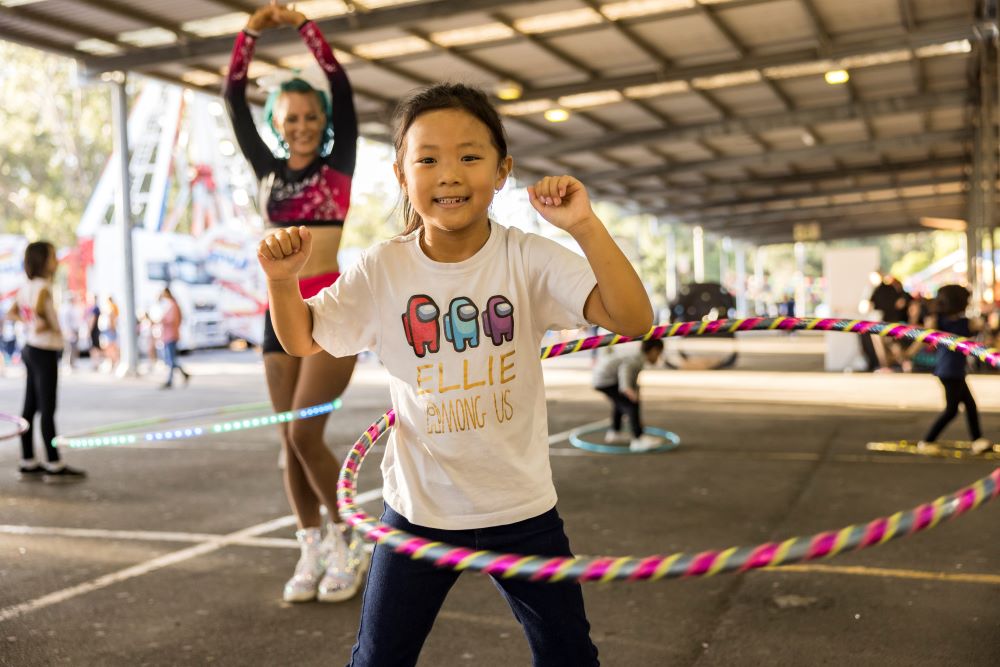 Young girl hula hooping.