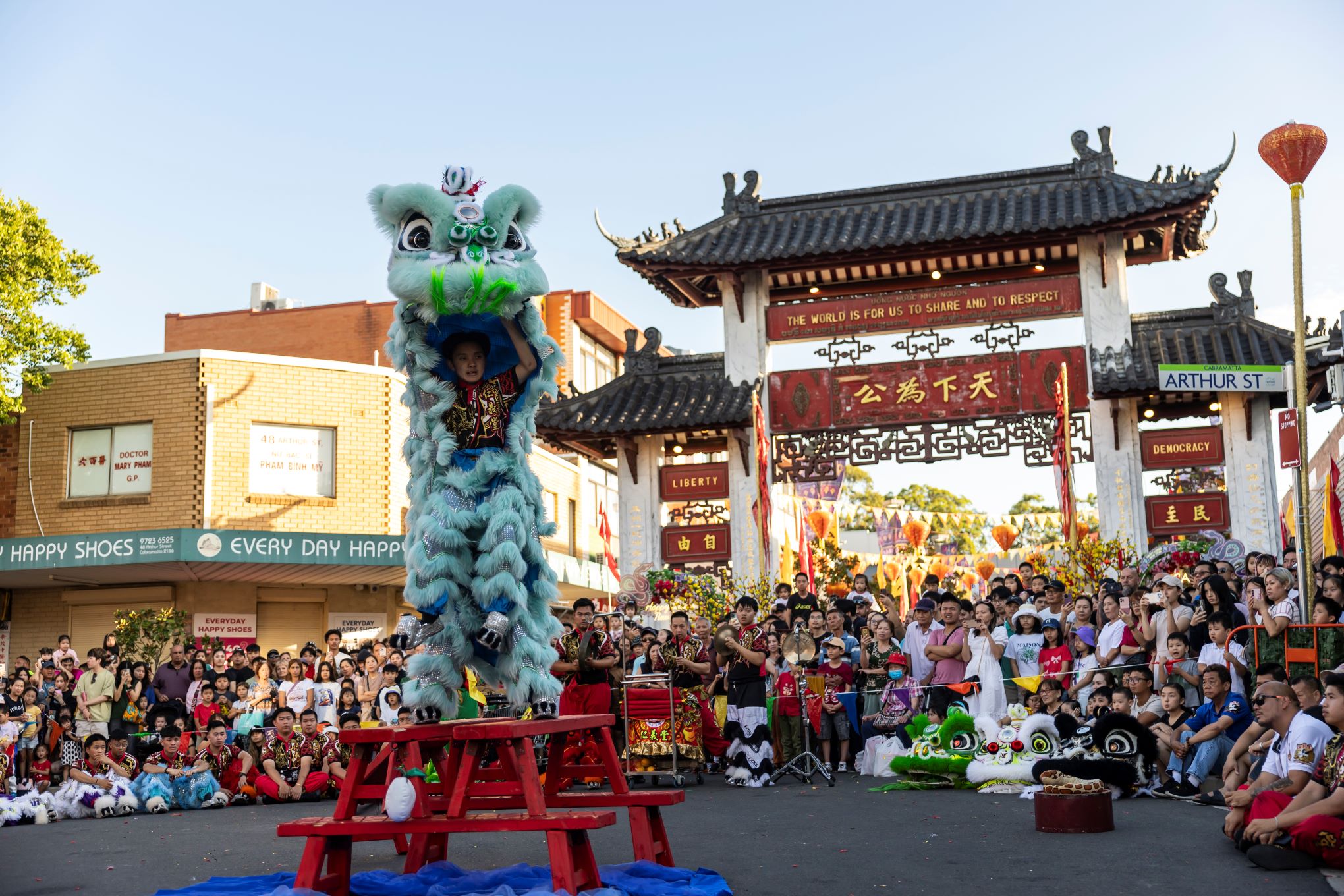 Lion Dance and Audience in front of Pai Lau Gate