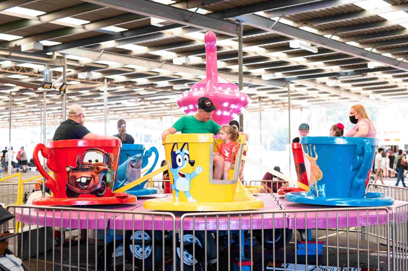 Families enjoying tea-cup ride.