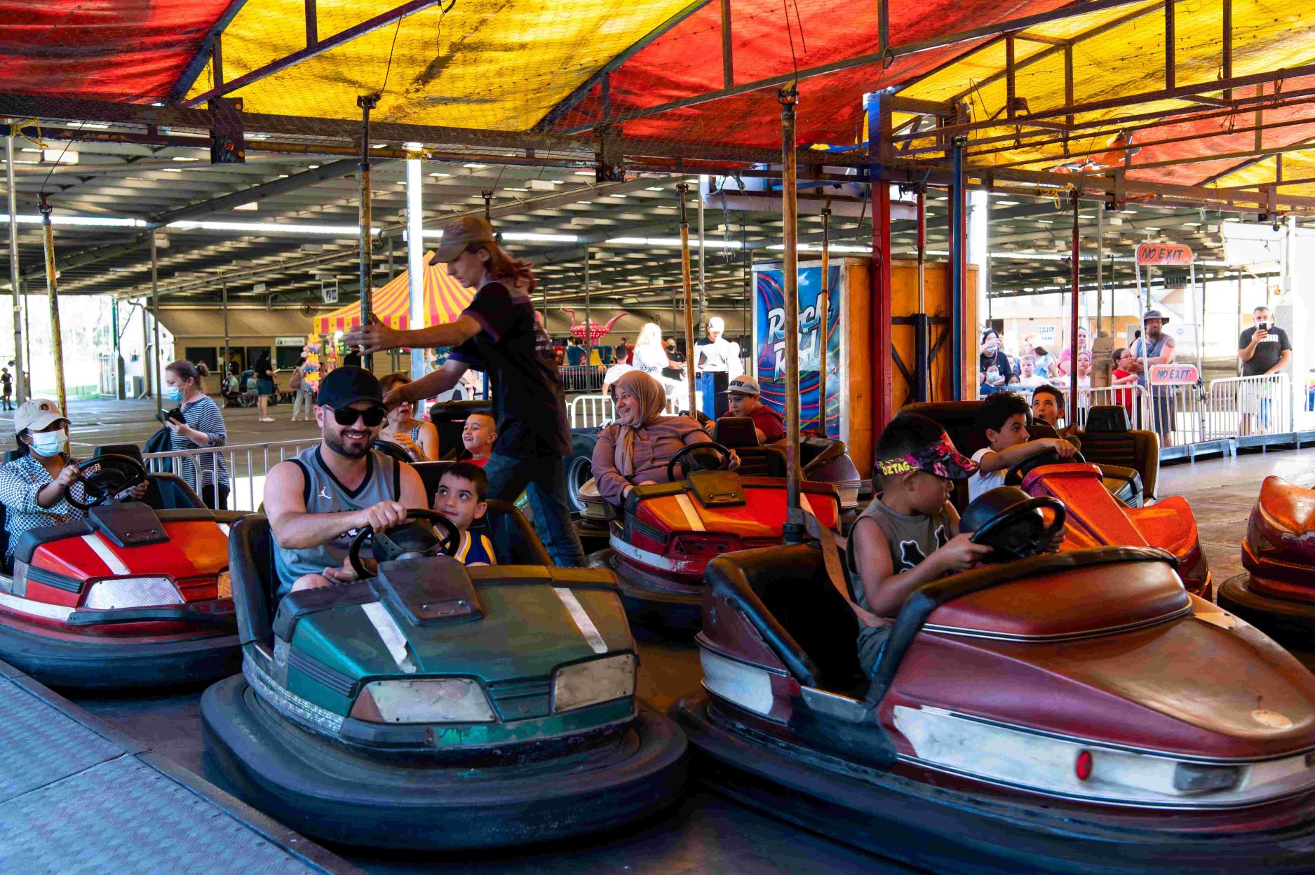 Families riding dodgem cars.