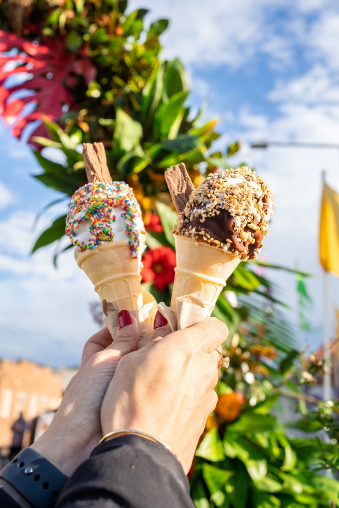 Two-ice-cream-cones-being-held-in-the-air