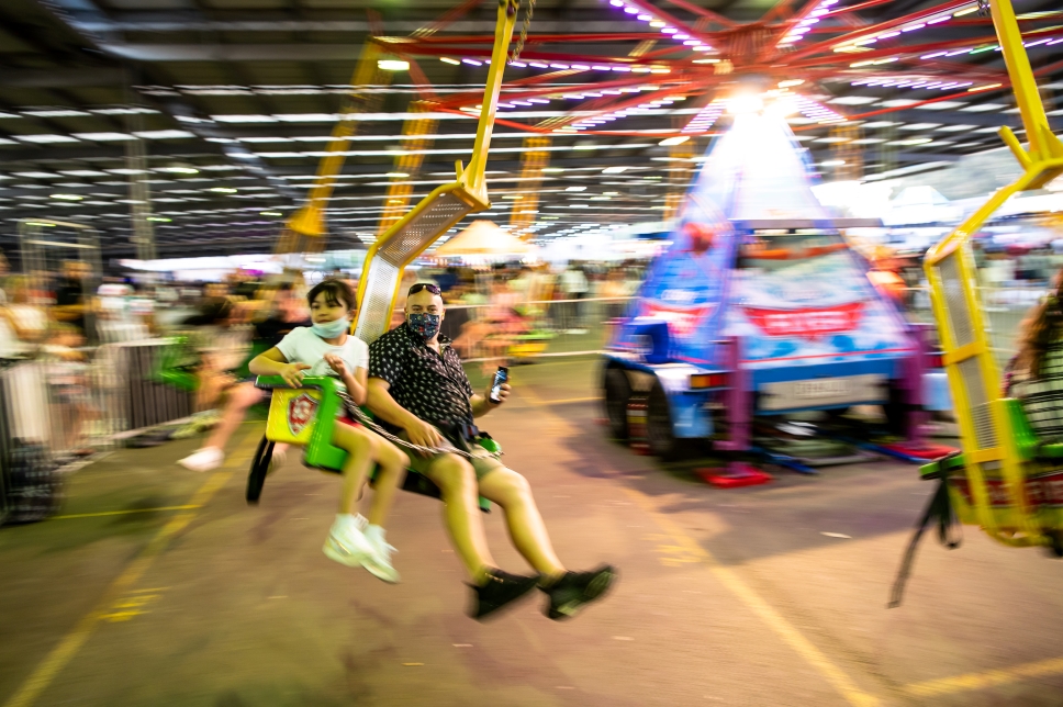 Two people on the high-flyer ride.